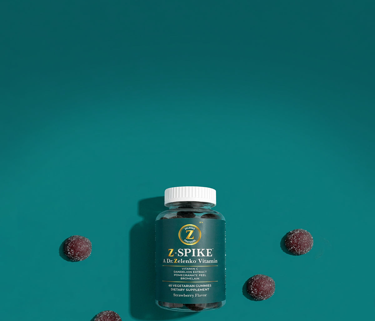Bottle of Z-Spike with gummies around it on teal background